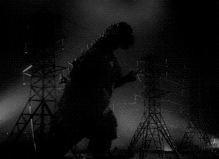 Large reptile dinosaur creature stumbling into electricity wires. Sparks everywhere. A bad metaphor for lumbering IT departments needing to be shocked into sense.