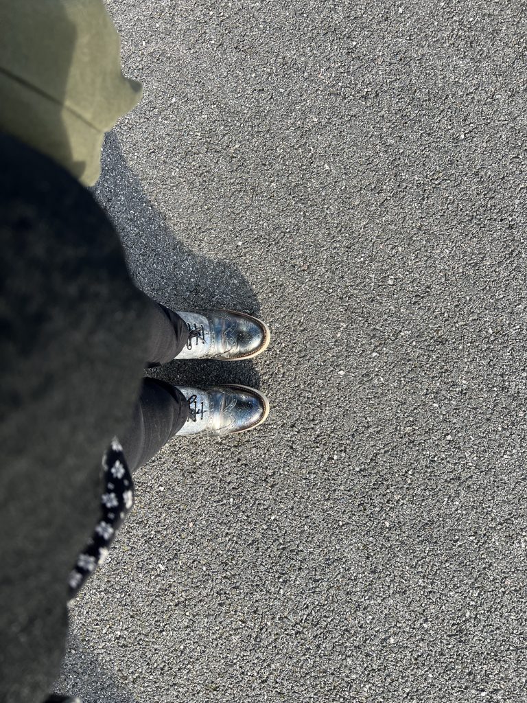 A picture of my feet with some silver and blue brogues on them. 